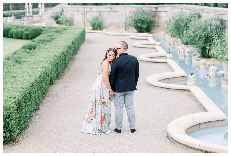 Engaged couple at Longwood Gardens posing for romantic engagement photo 