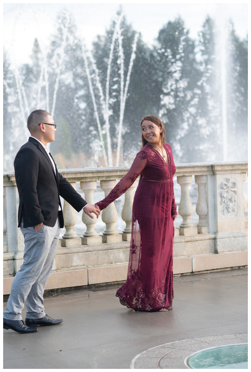 Joyful fountain engagement photo at Longwood Gardens
