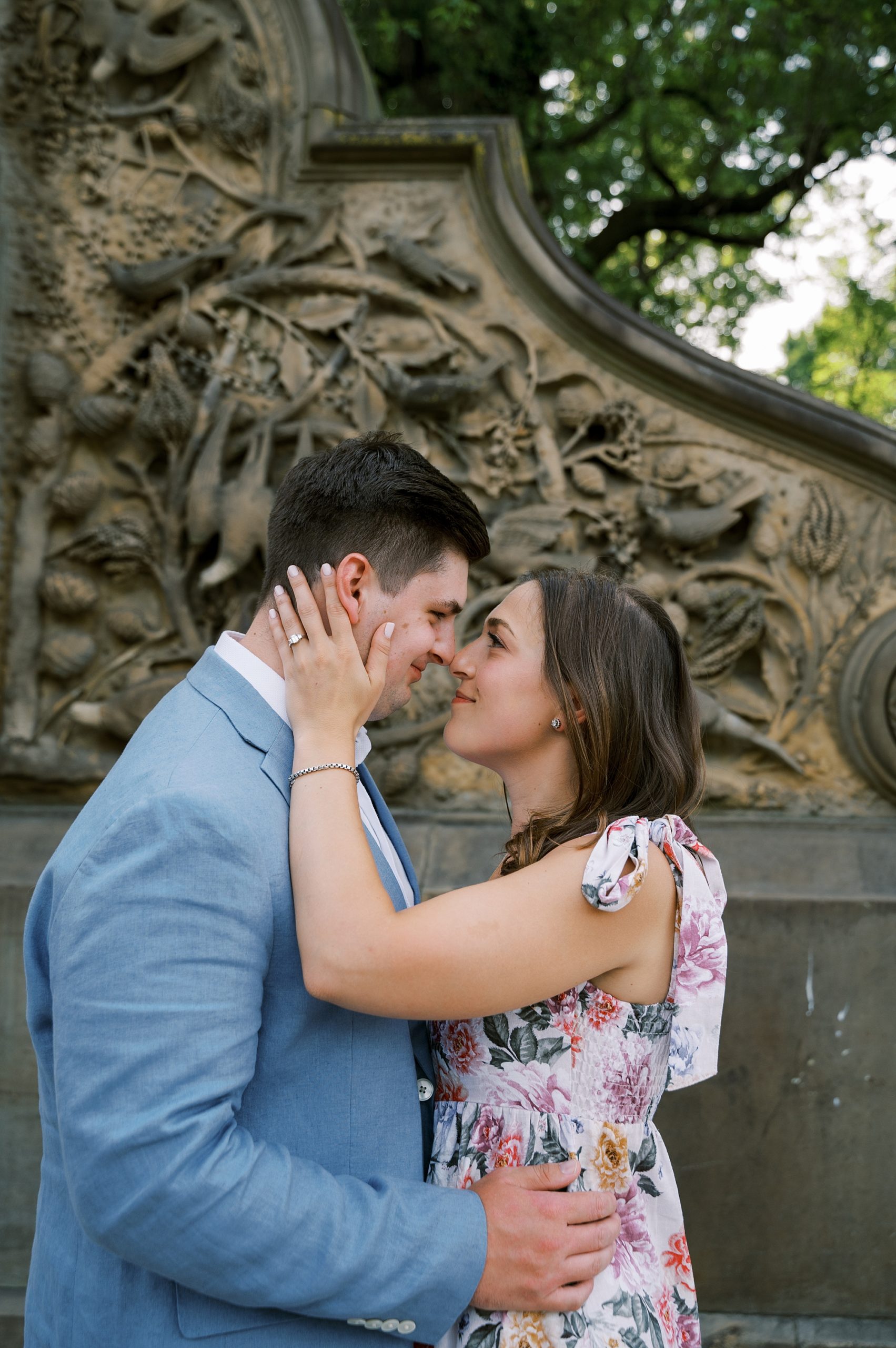 engaged couple hugs by stone staircase in Central Park