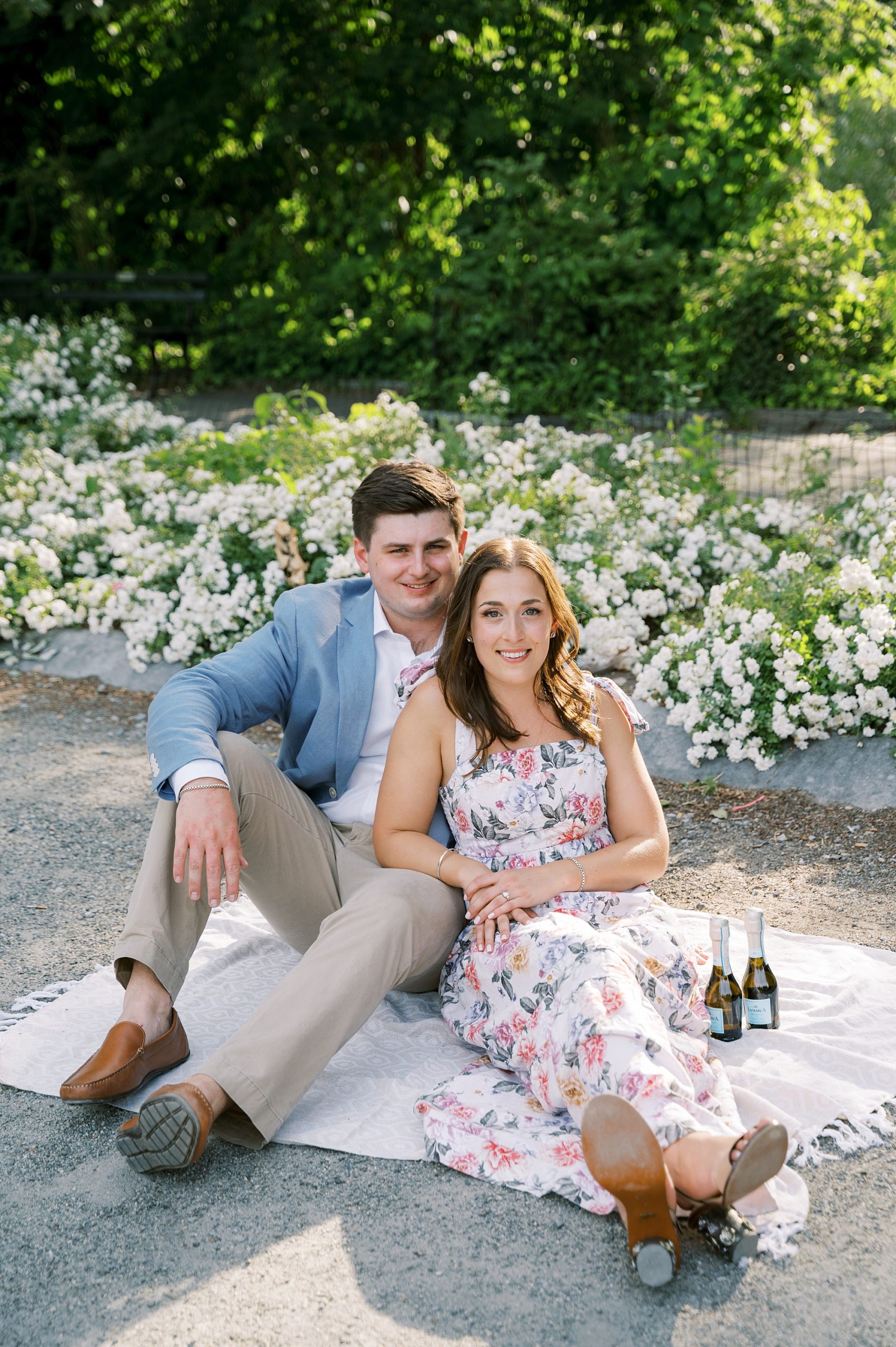 bride and groom sit on picnic blanket in Central Park