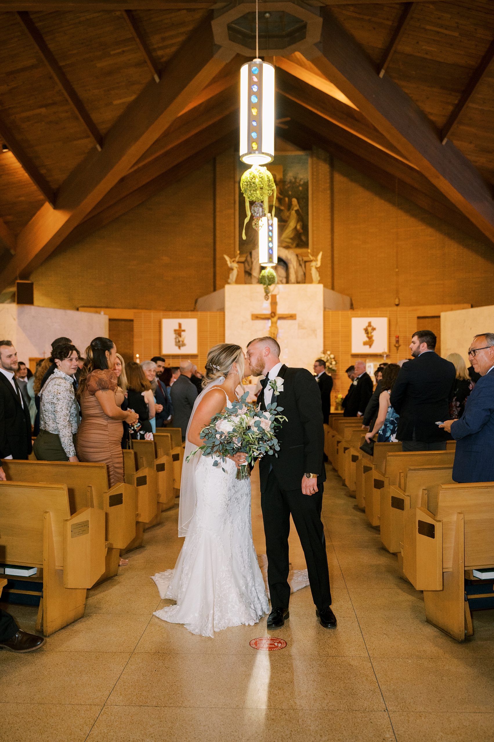 newlyweds walk up aisle after traditional church wedding ceremony in New Jersey