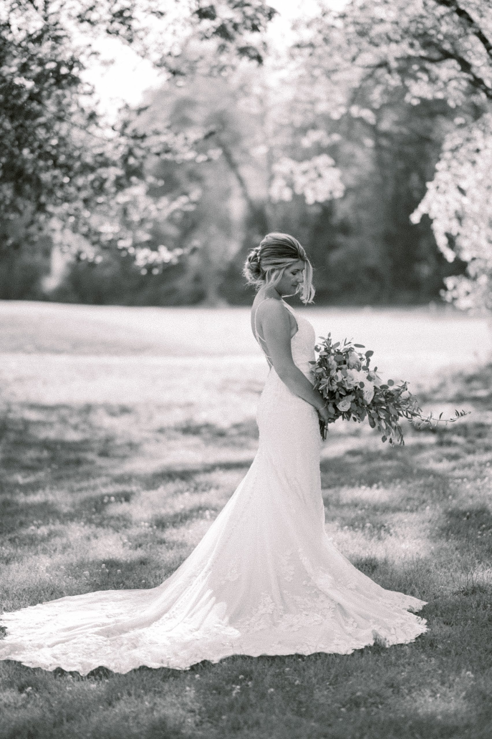 black and white bridal portrait of NJ bride holding full bouquet at The Grove at Centerton