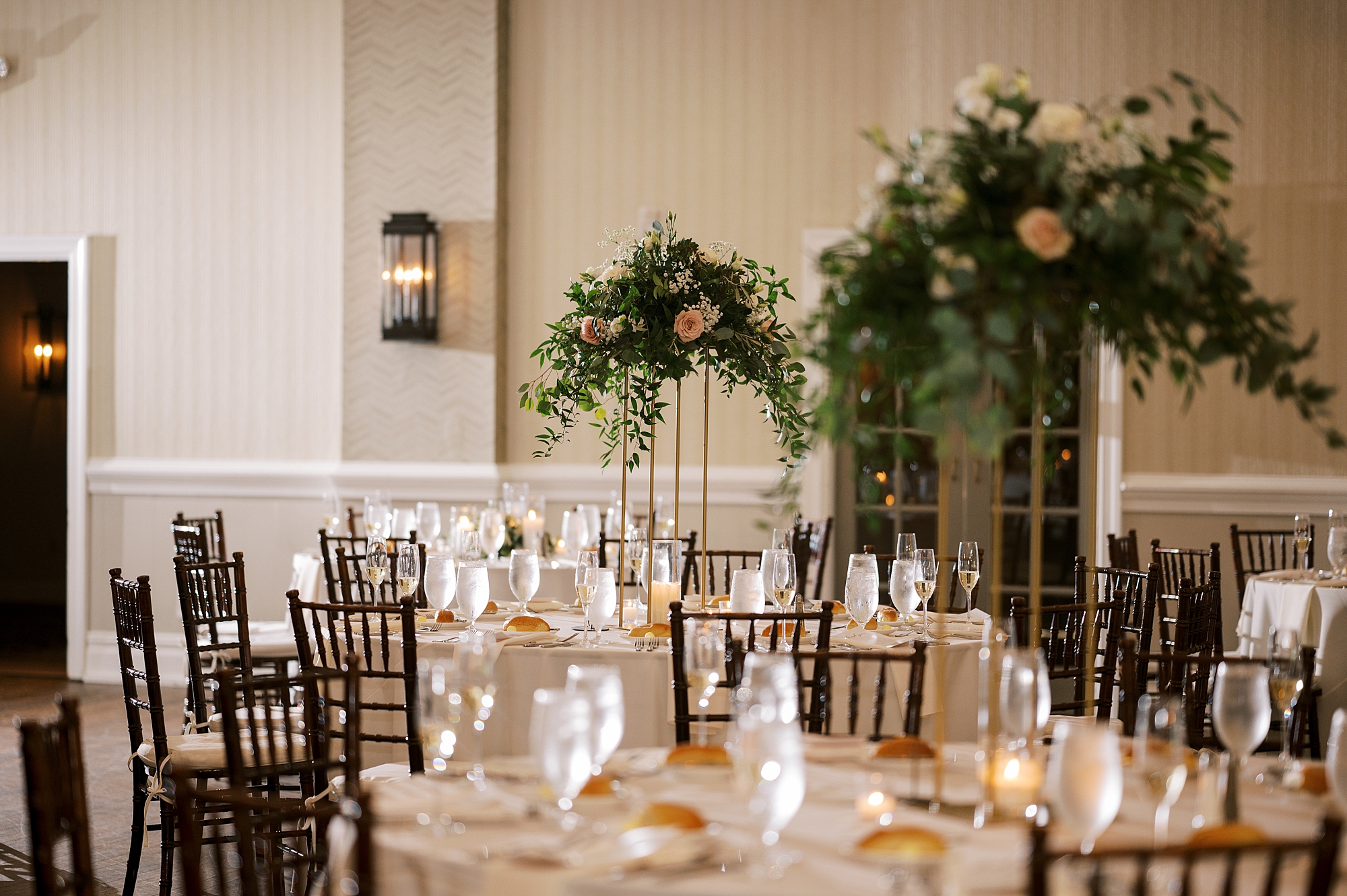 rustic wedding reception with tall floral centerpieces at The Grove at Centerton