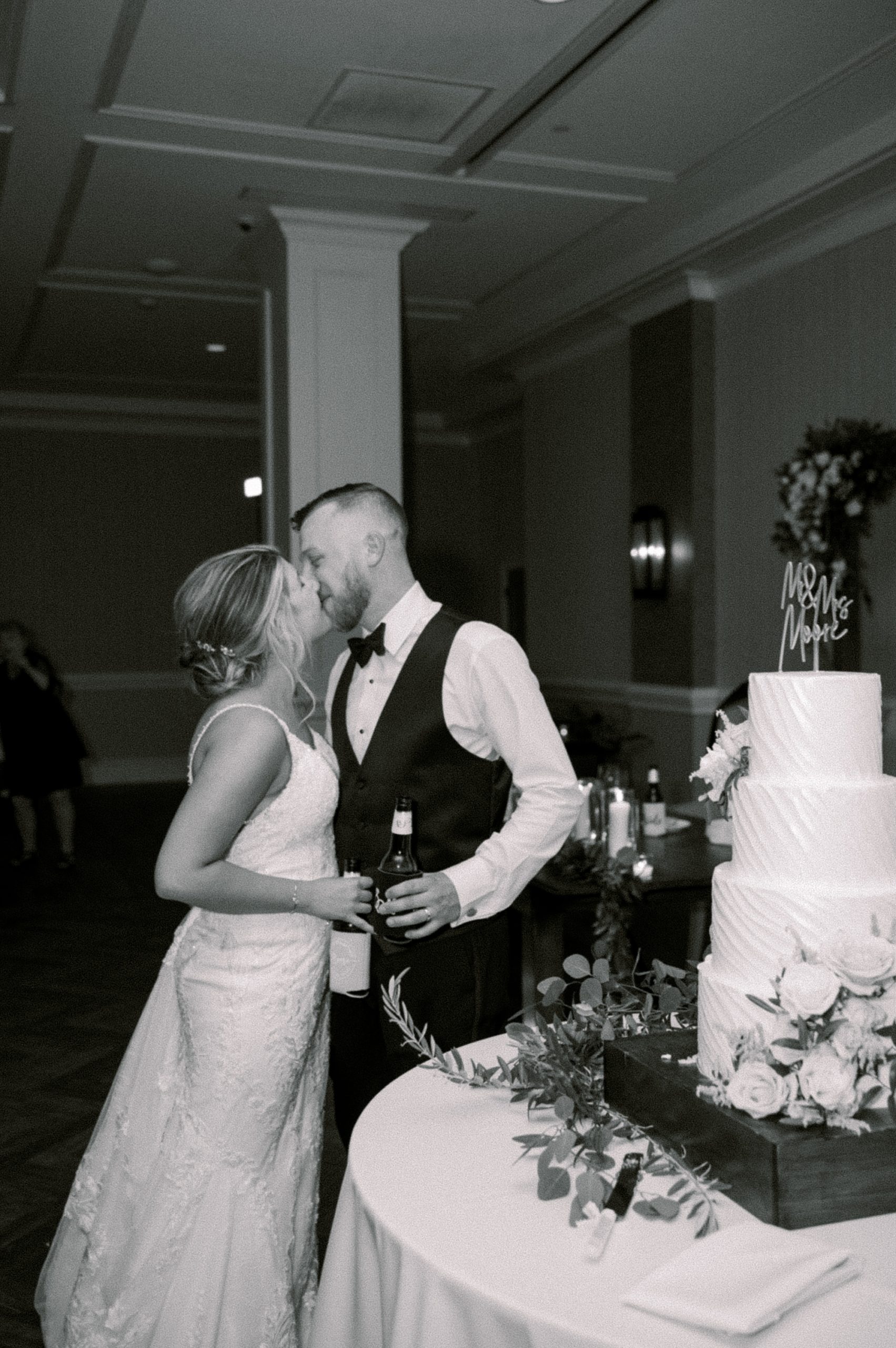 bride and groom kiss during cake cutting at The Grove at Centerton