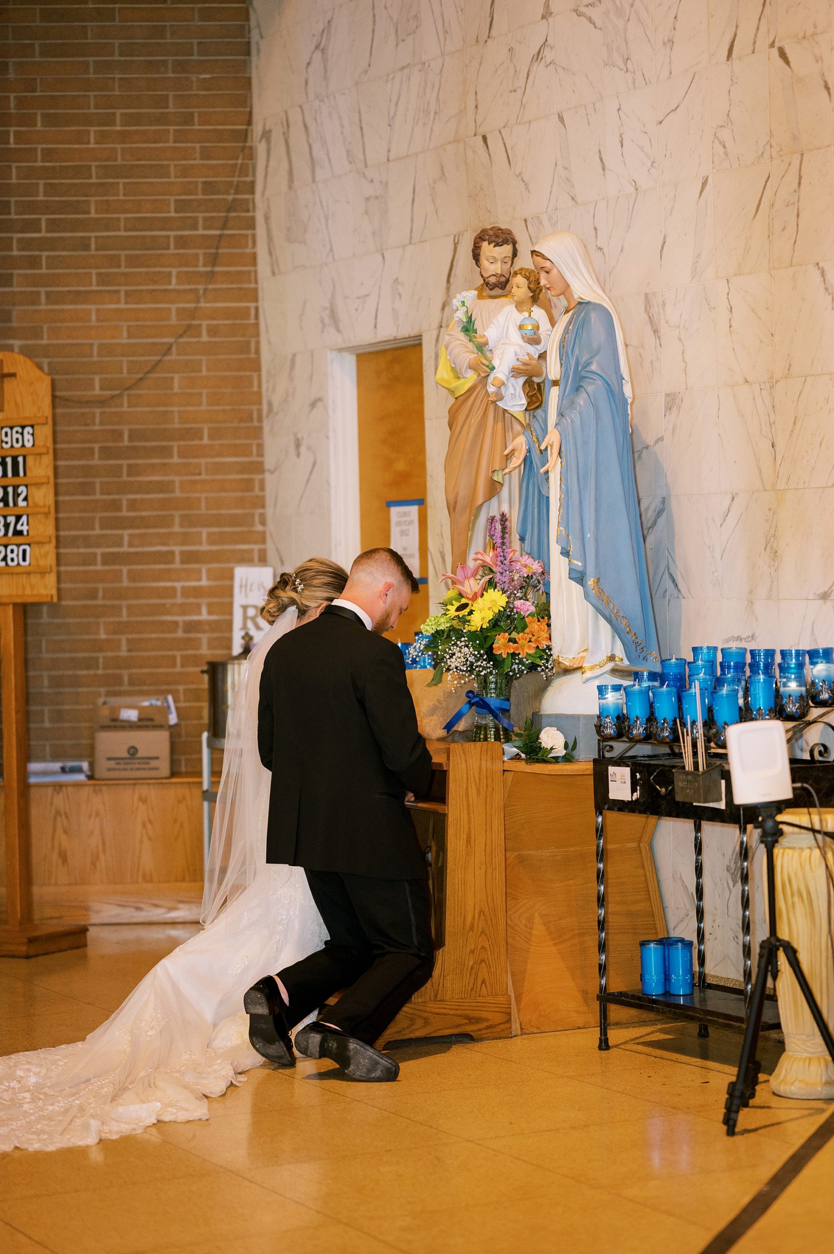 couple kneels during traditional church wedding ceremony in New Jersey
