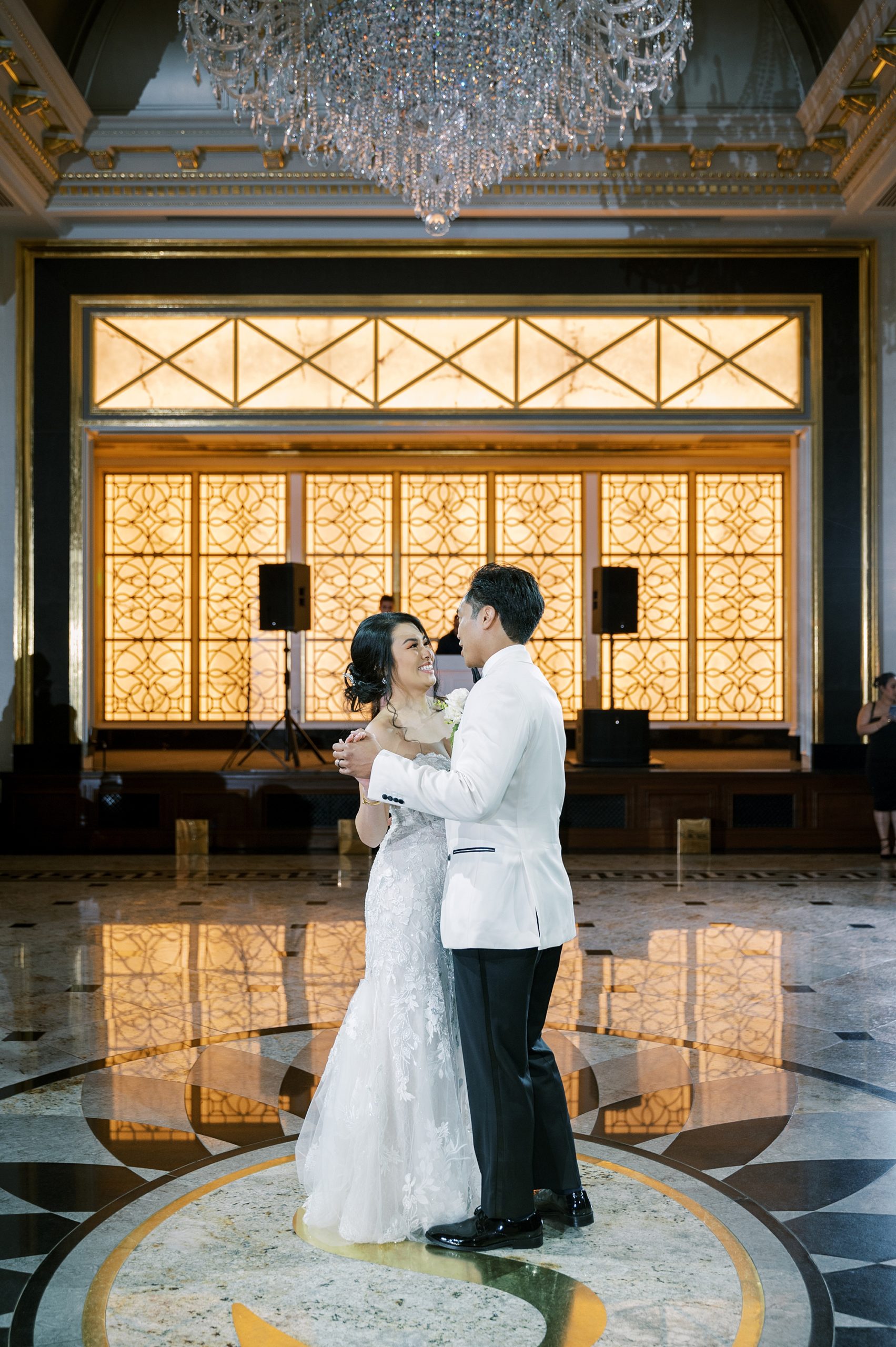 bride dances with groom in white tux jacket in ballroom of Shadowbrook at Shrewsbury