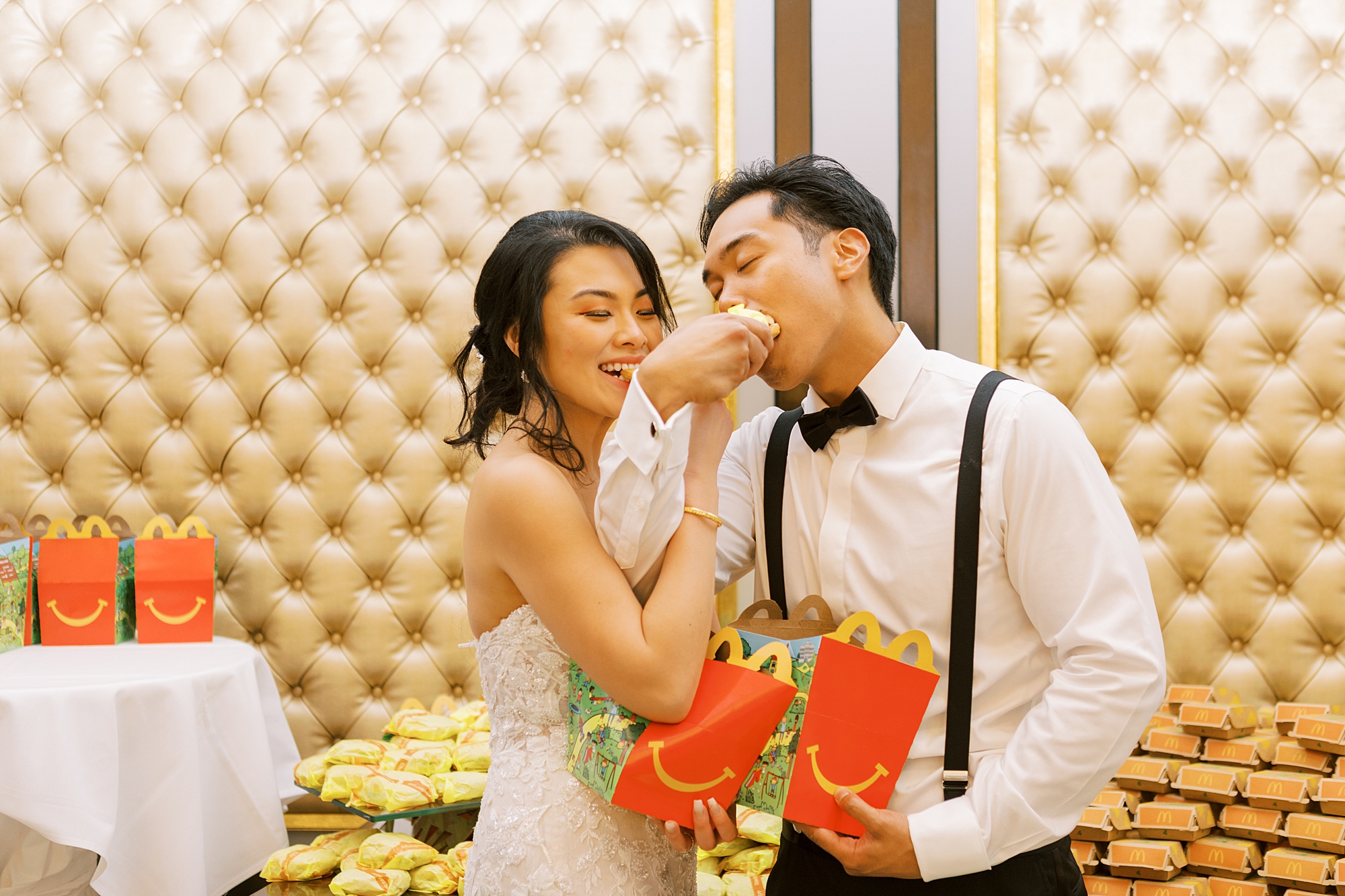 bride and groom feed each other McDonalds during reception 