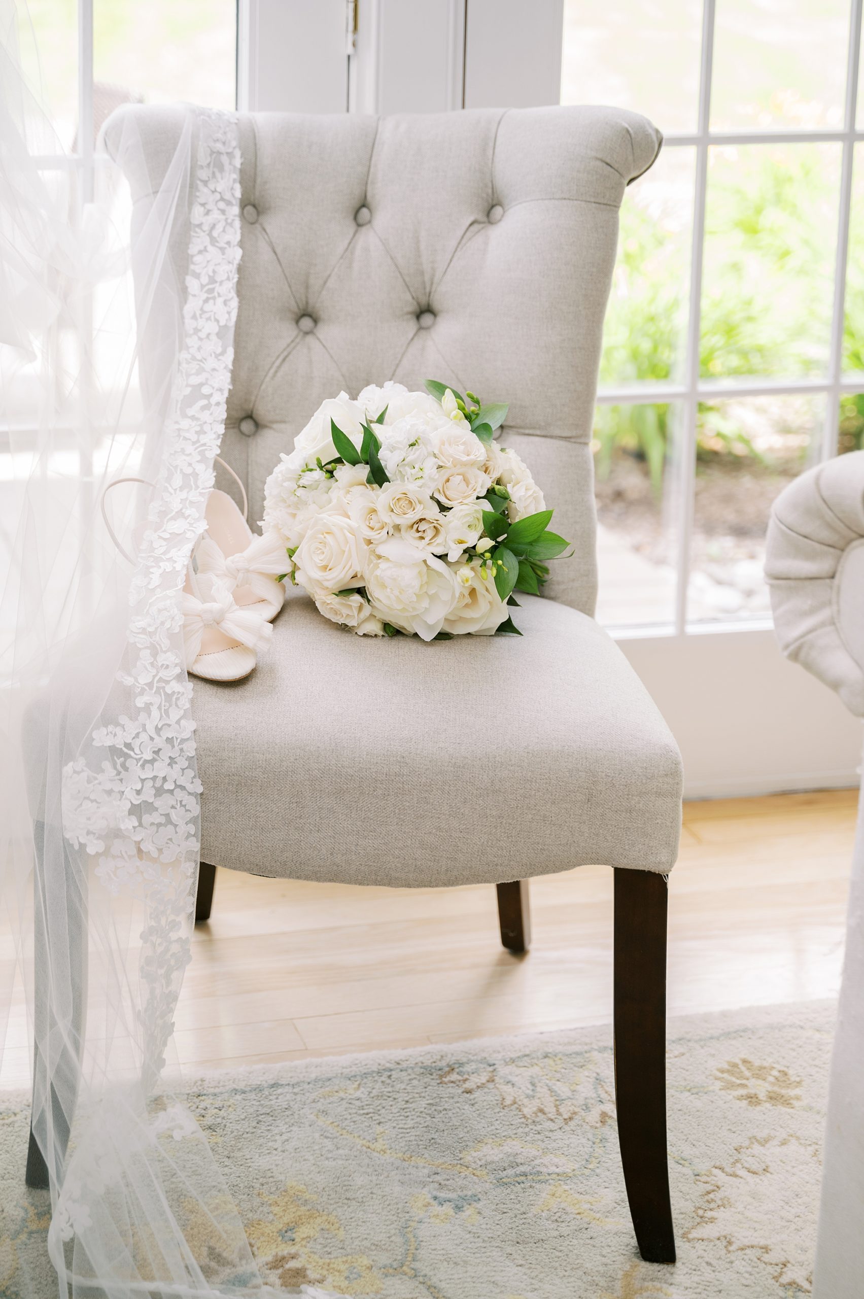 wedding bouquet sits on grey chair
