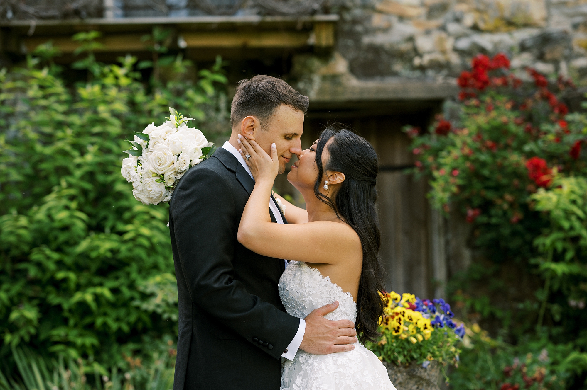 bride and groom kiss in gardens at Crossed Keys Estate