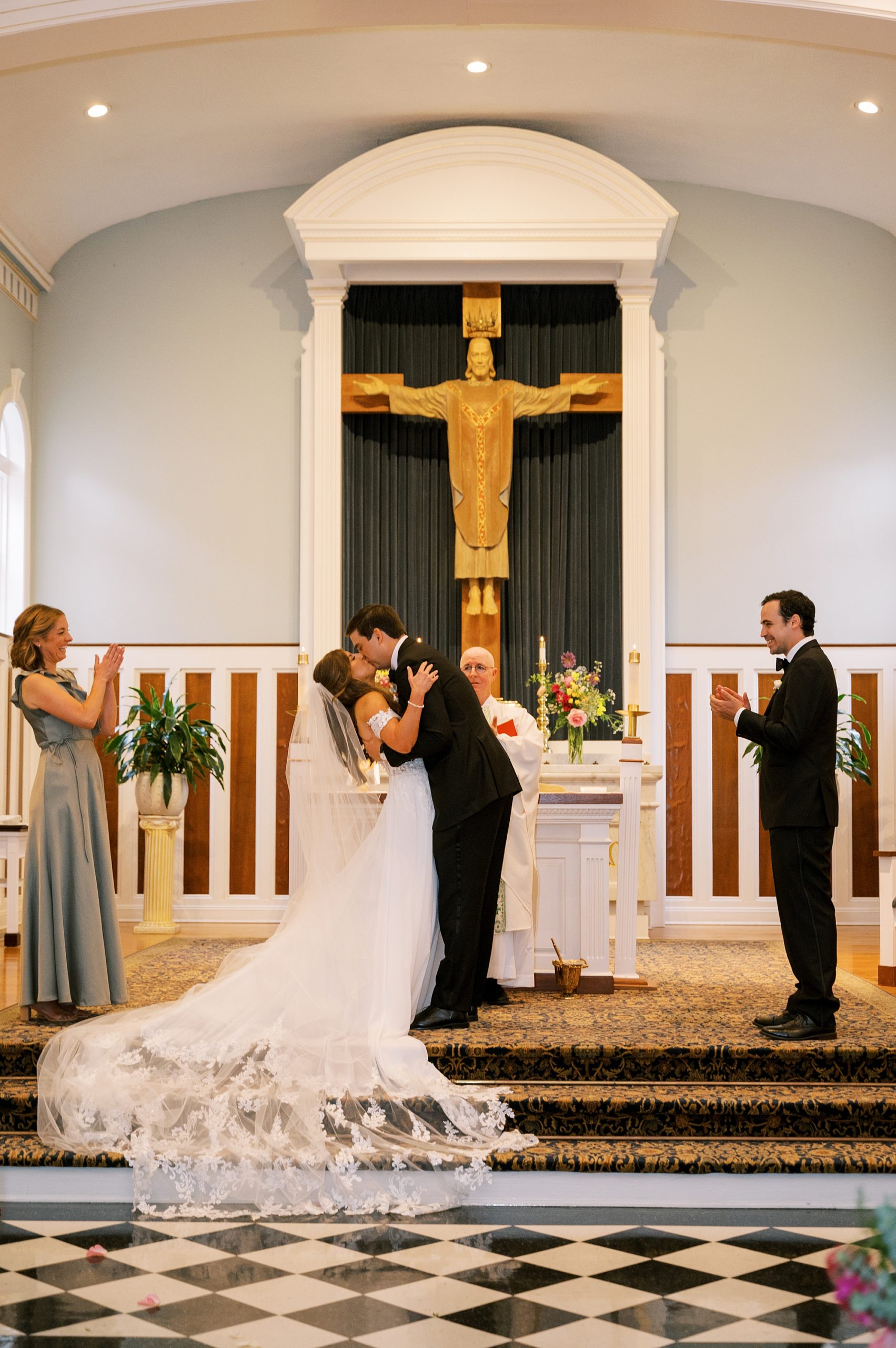bride and groom kiss during church ceremony