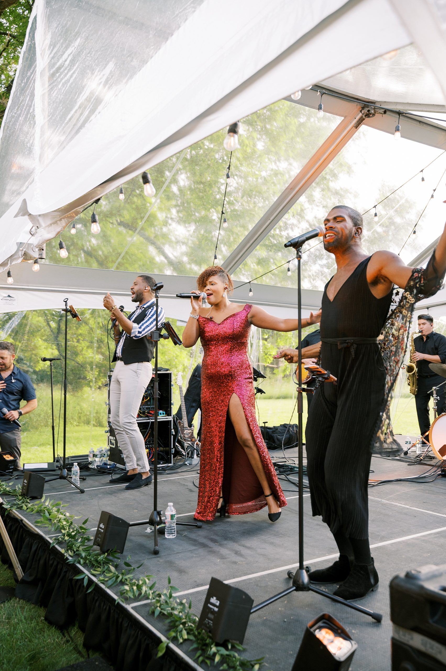 band performs during tented wedding reception at Willowwood Arboretum
