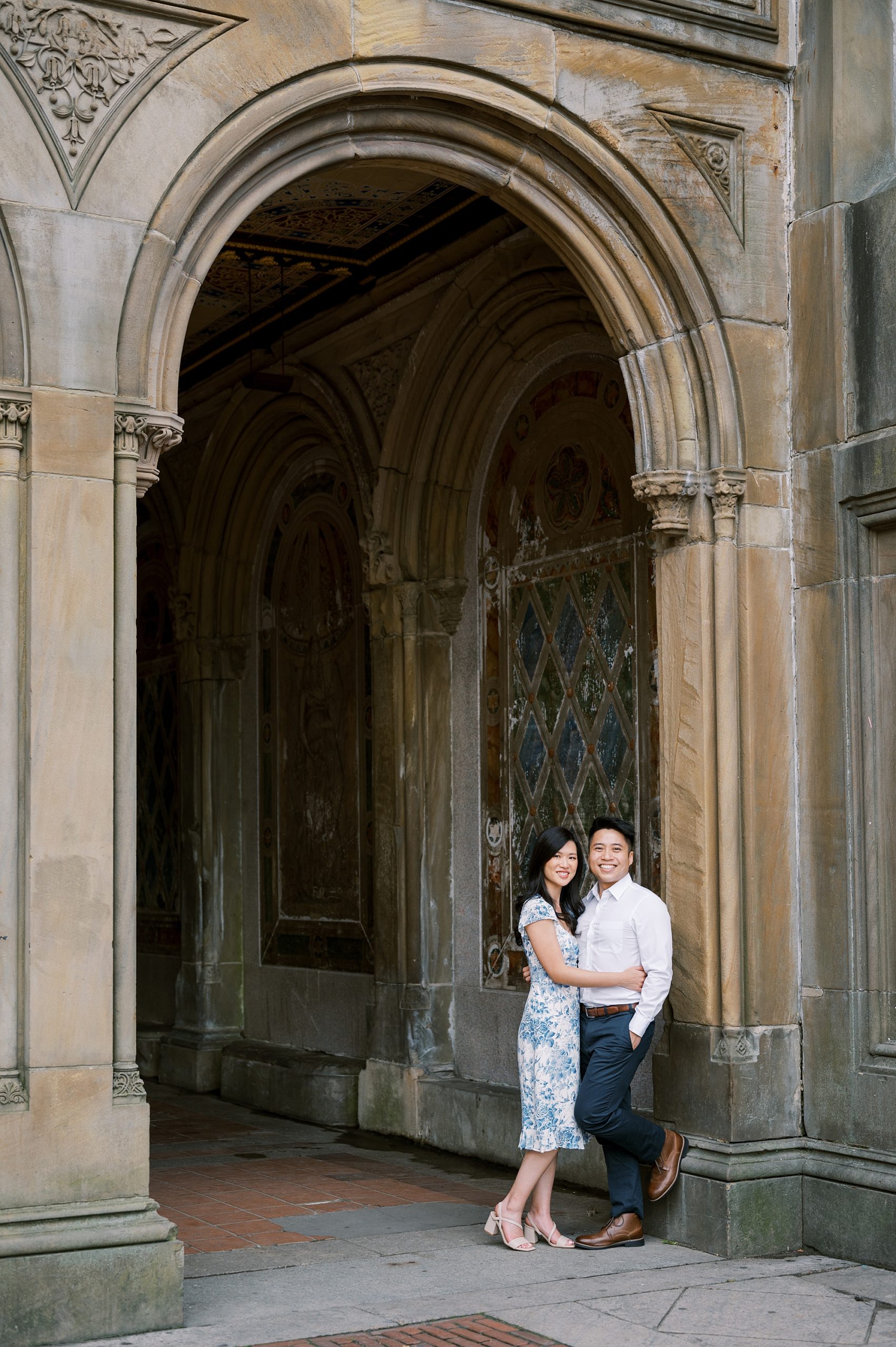 engaged couple stands in doorframe at Central Park