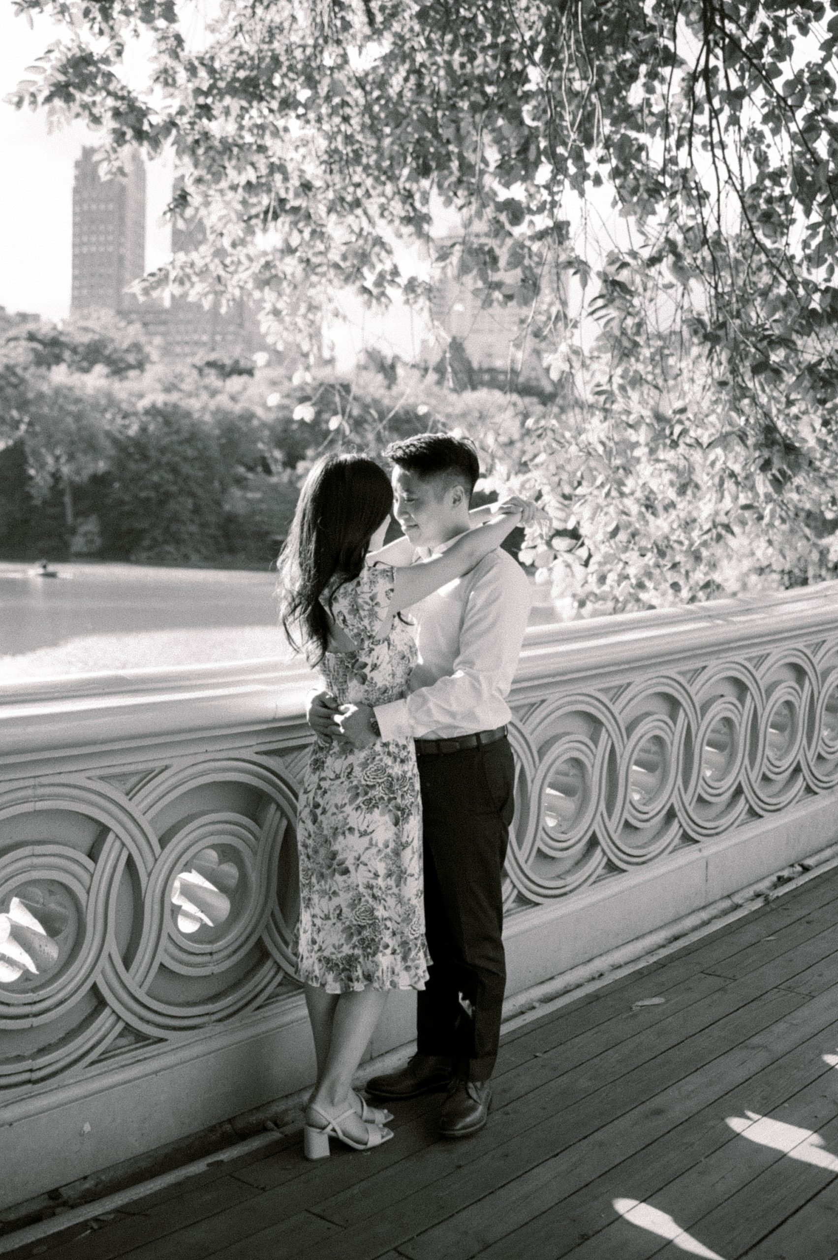 woman hugs fiancee on bridge in Central Park
