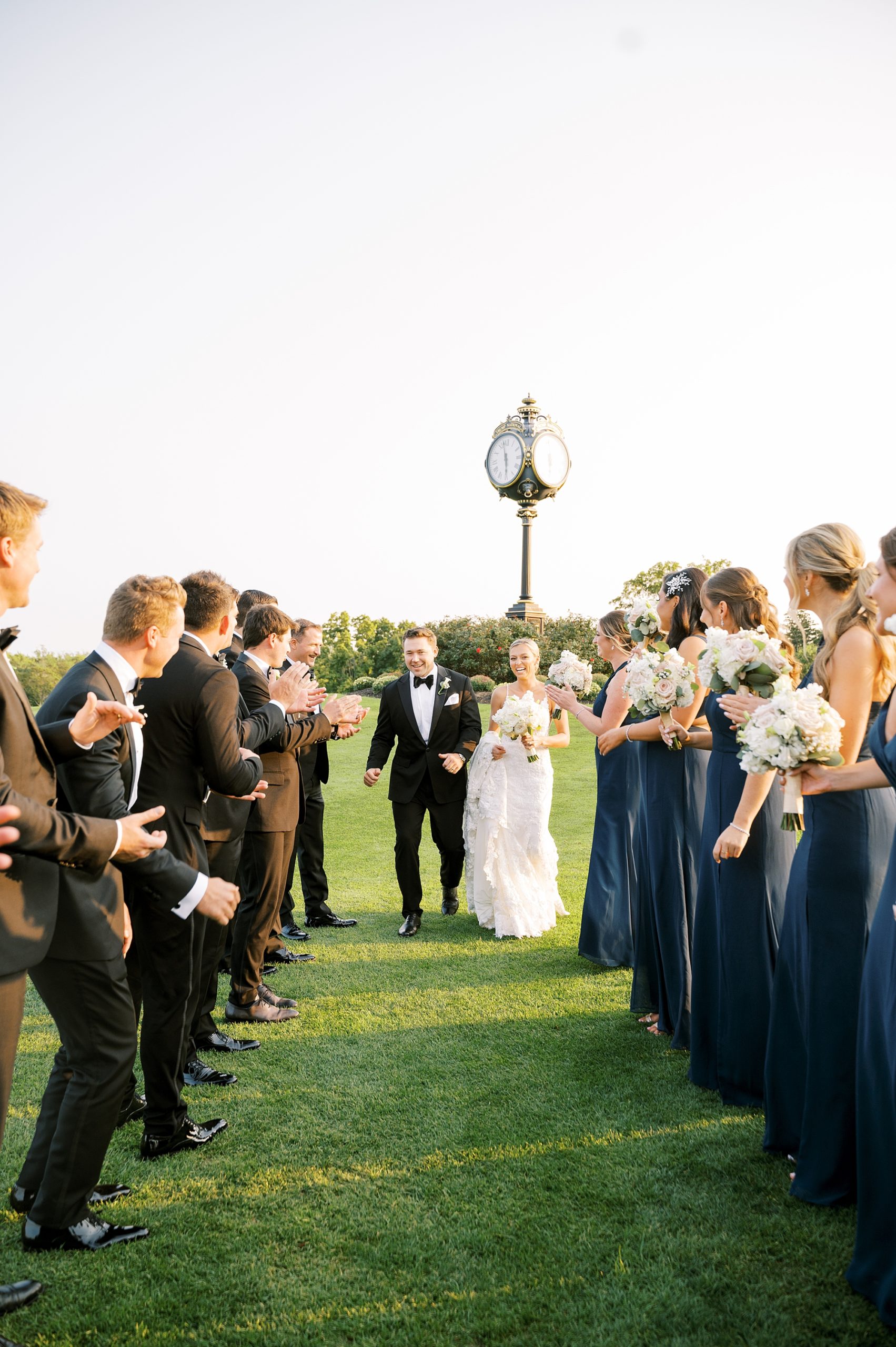 newlyweds walk between wedding party at Trump National Golf Club Westchester