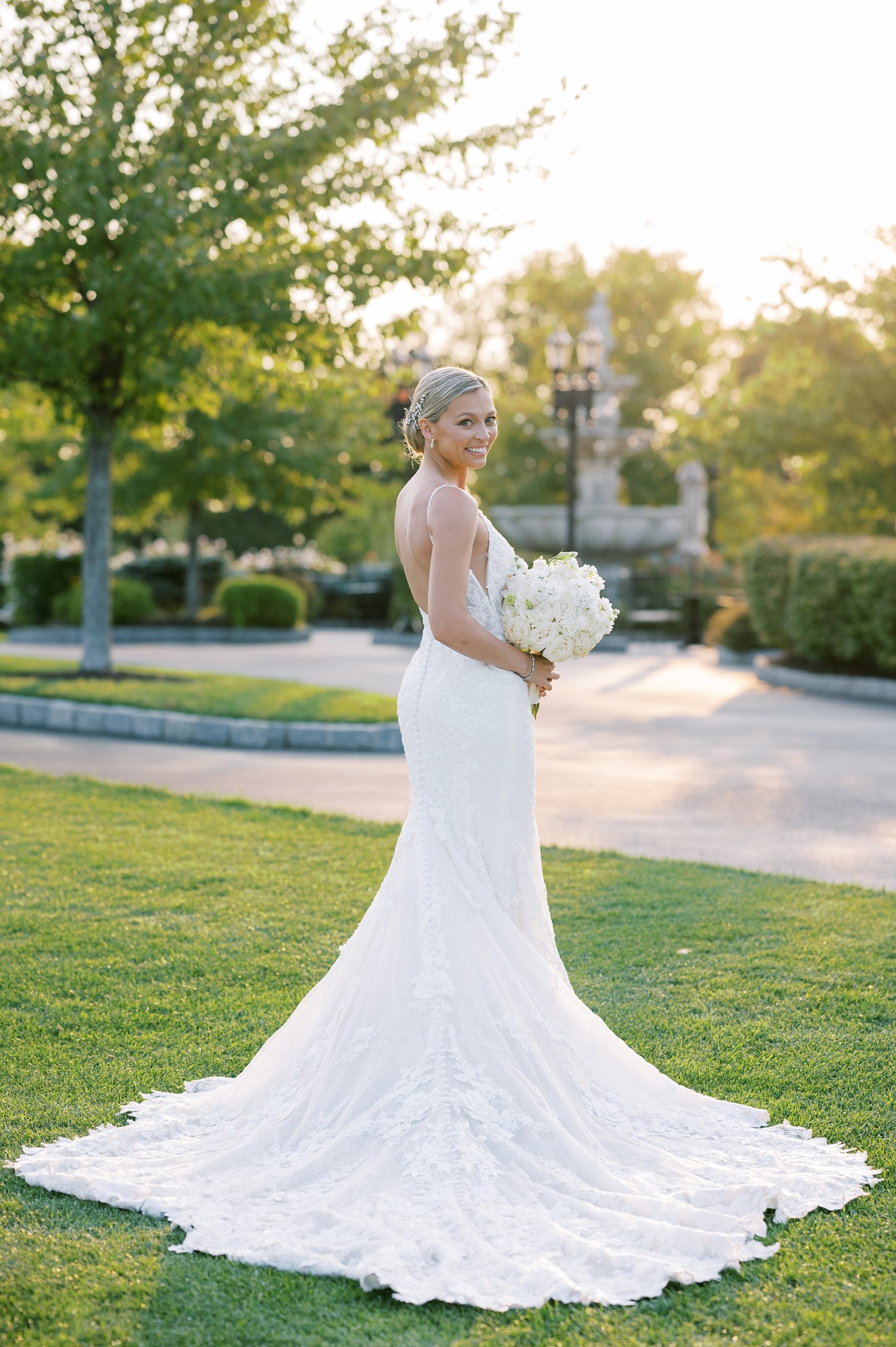 bride poses on green at Trump National Golf Club Westchester