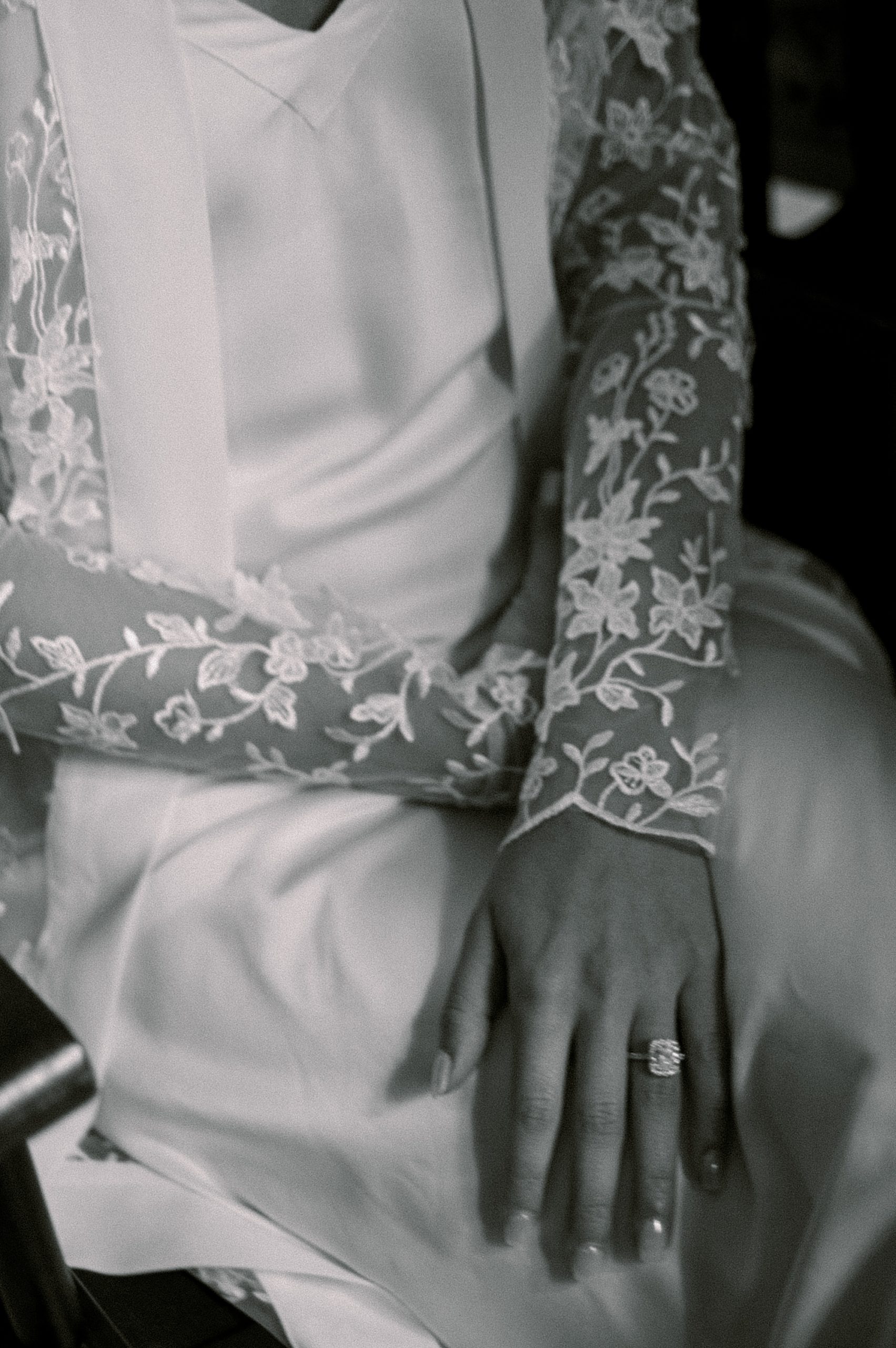bride sits in lace robe preparing for Trump National Golf Club Westchester wedding