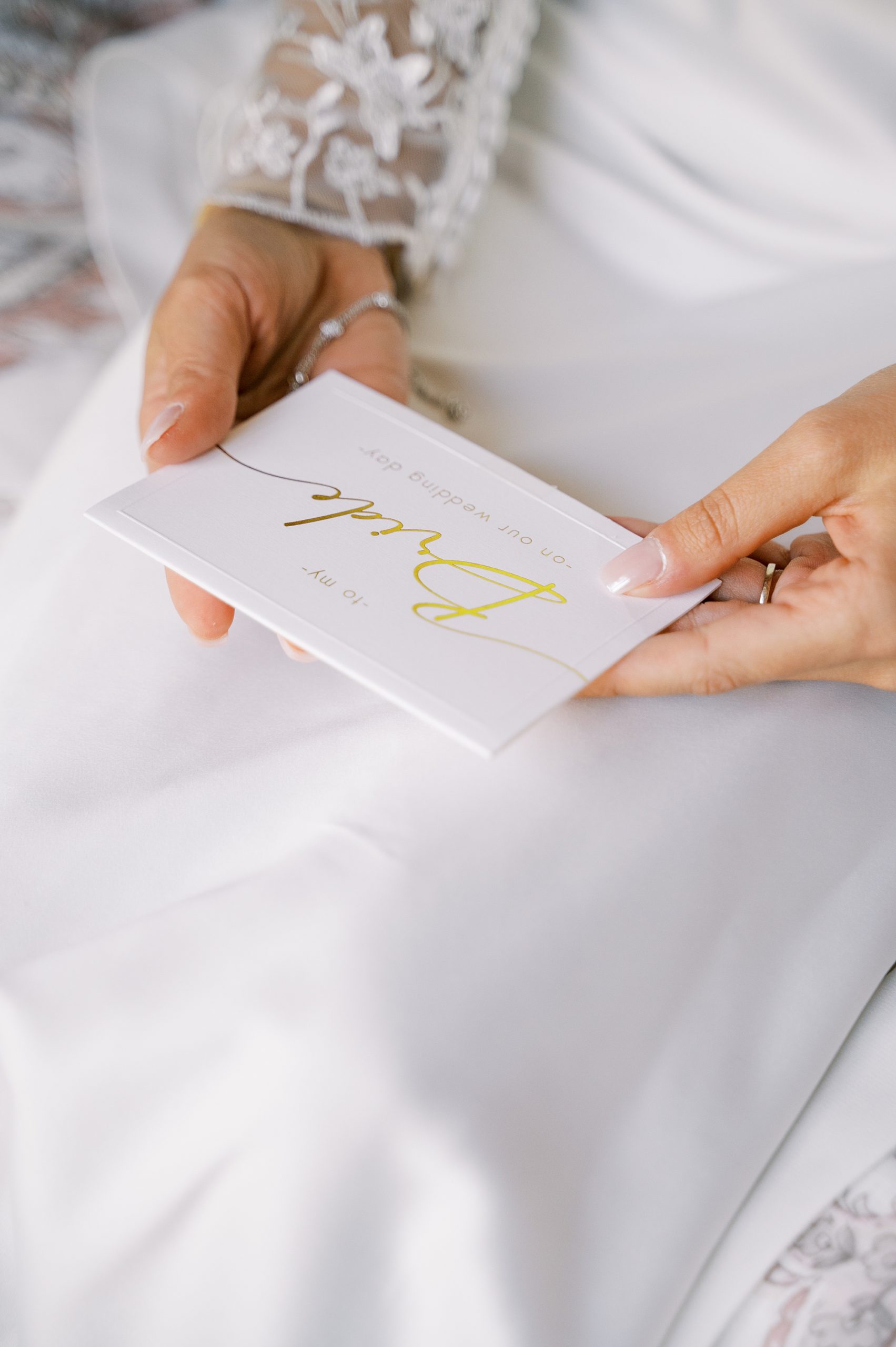 bride holds letter with gold "bride" on front 