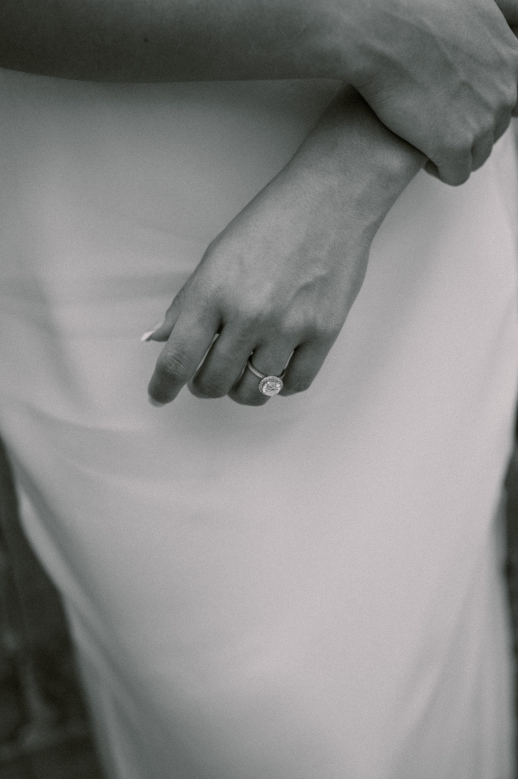 editorial inspired image of woman holding arm showing off ring 