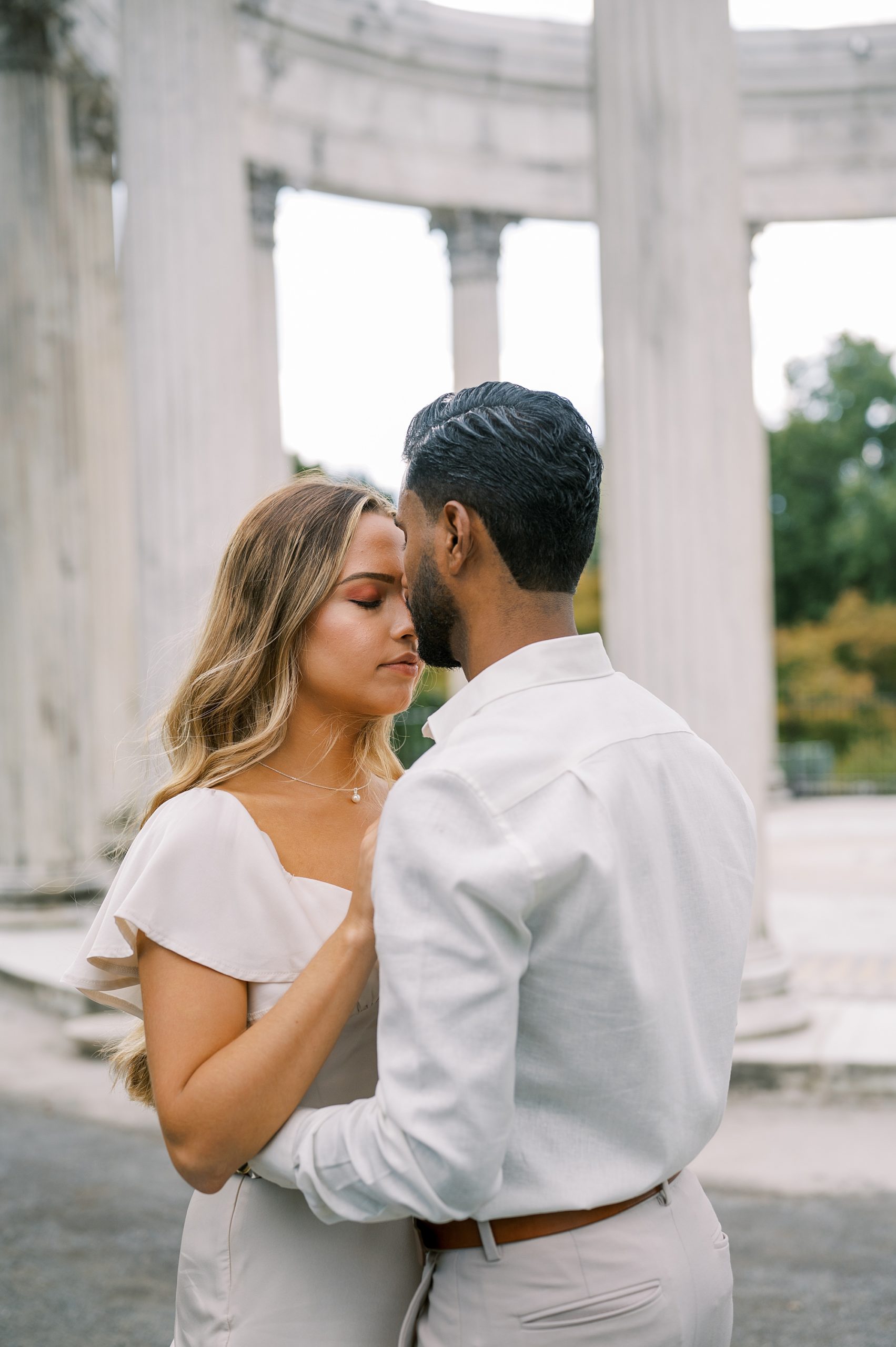 man kisses fiancee during Untemyer Gardens Conservancy engagement photos 