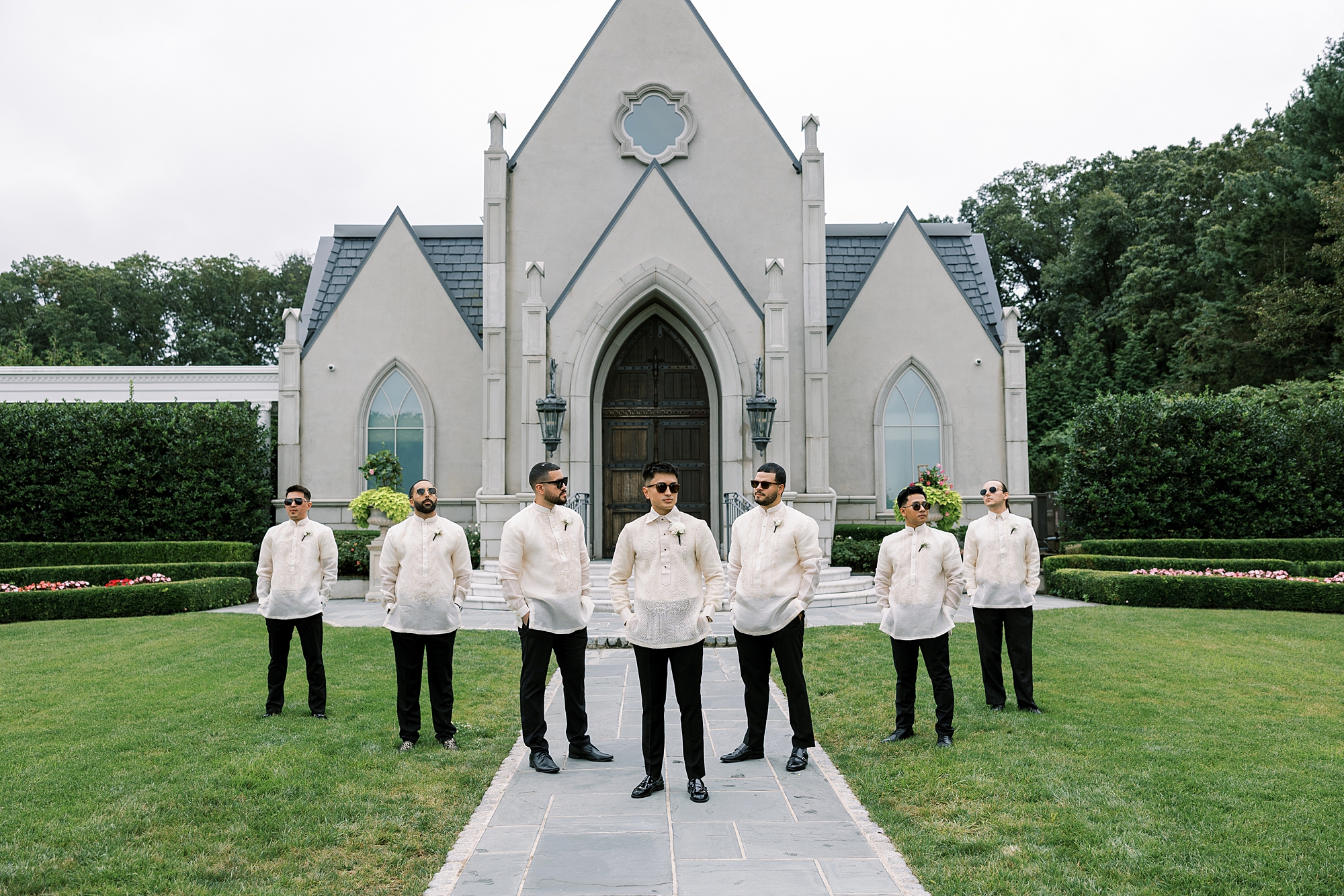 groom and groomsmen stand in traditional filipino wedding attire outside Park Chateau Estate chapel