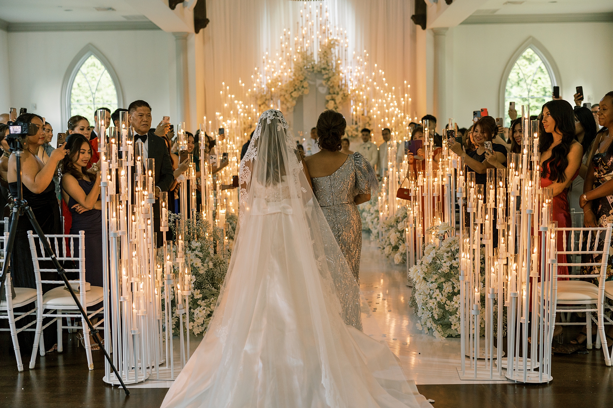 mother walks bride down aisle for candlelit ceremony inside the Park Chateau Estate chapel