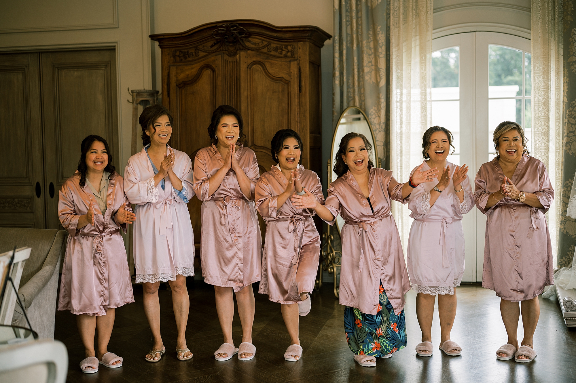 bridesmaids cheer during first look with bride in suite at Park Chateau Estate