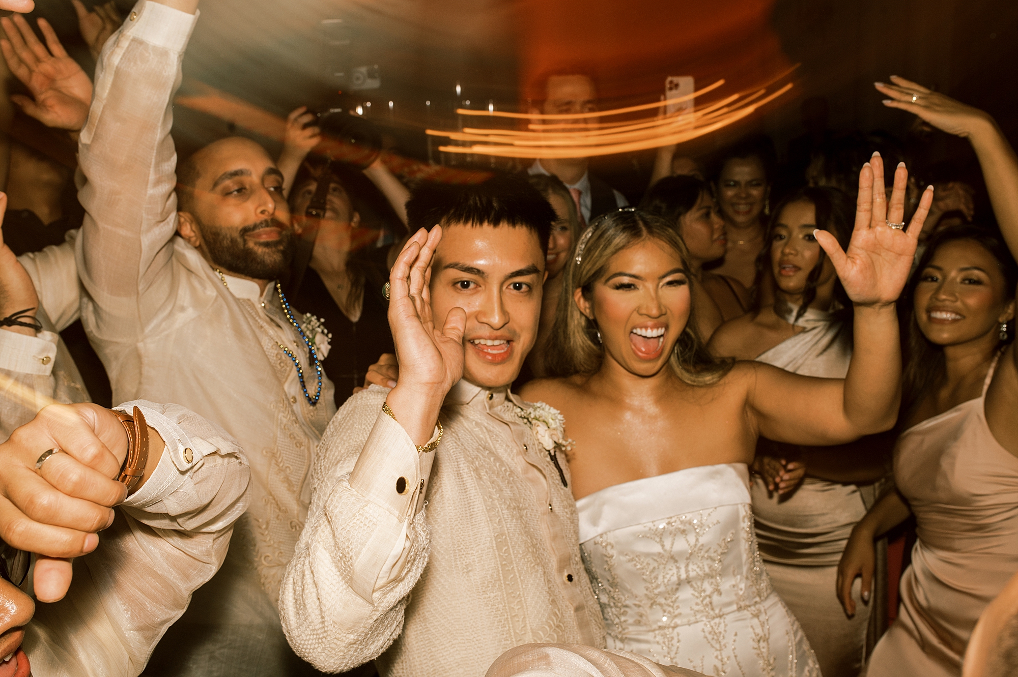 bride and groom dance with wedding guests during reception at Park Chateau Estate