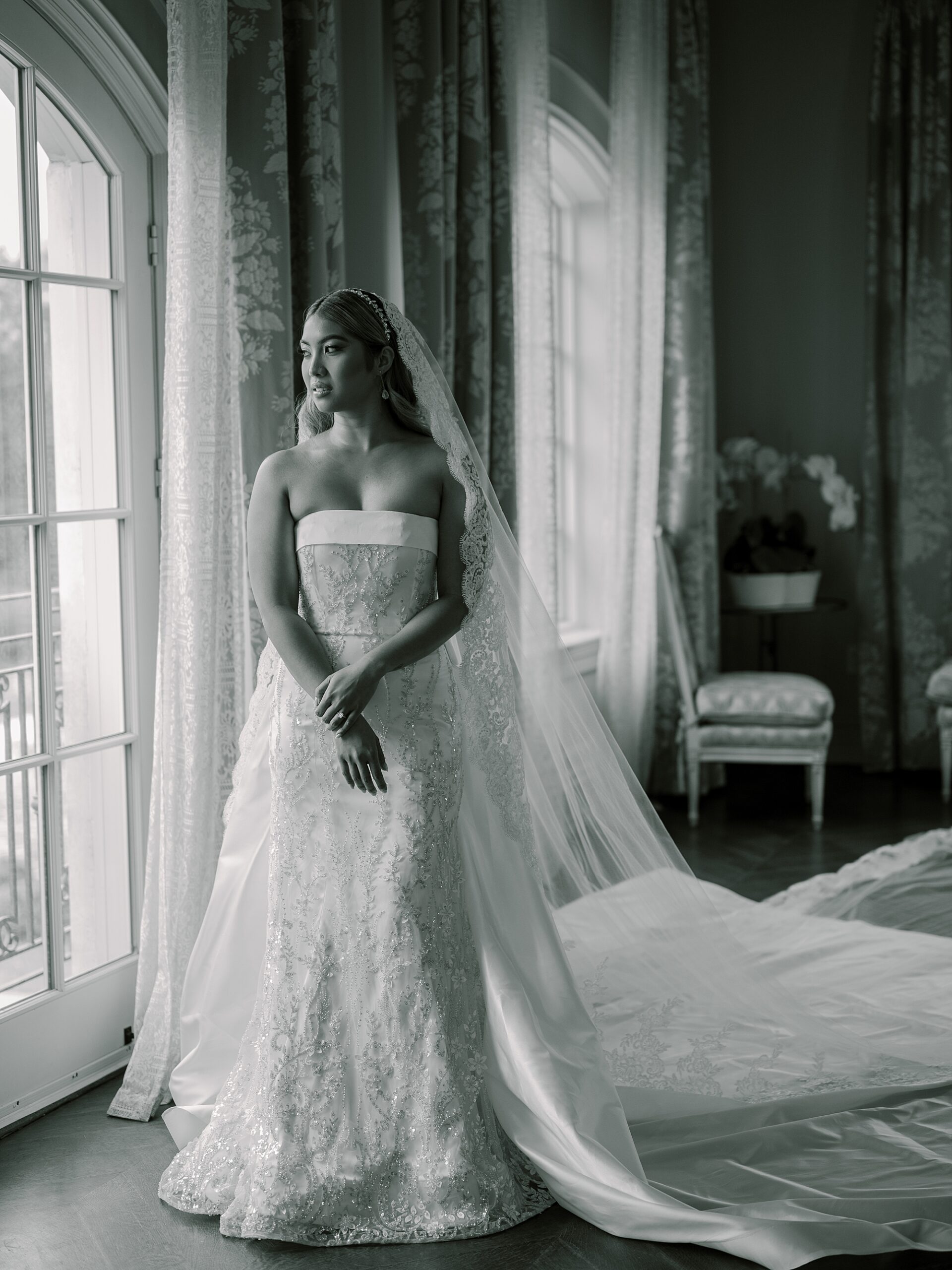 bride posts in window of bridal suite at Park Chateau Estate