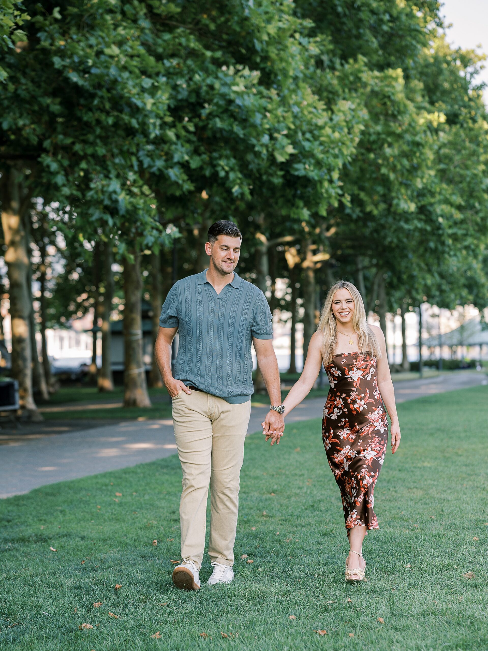 man and woman hold hands walking through Lackawanna Park