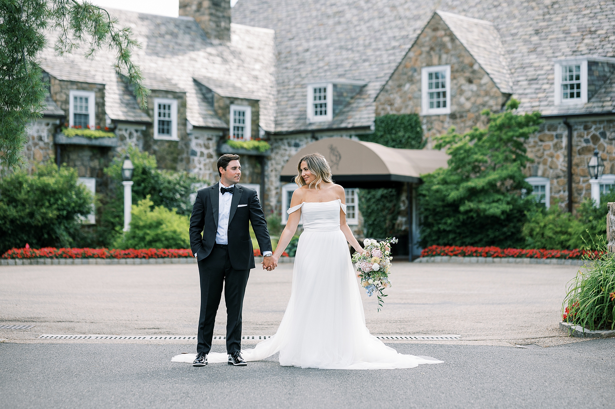 married couple holds hands outside NJ wedding venue