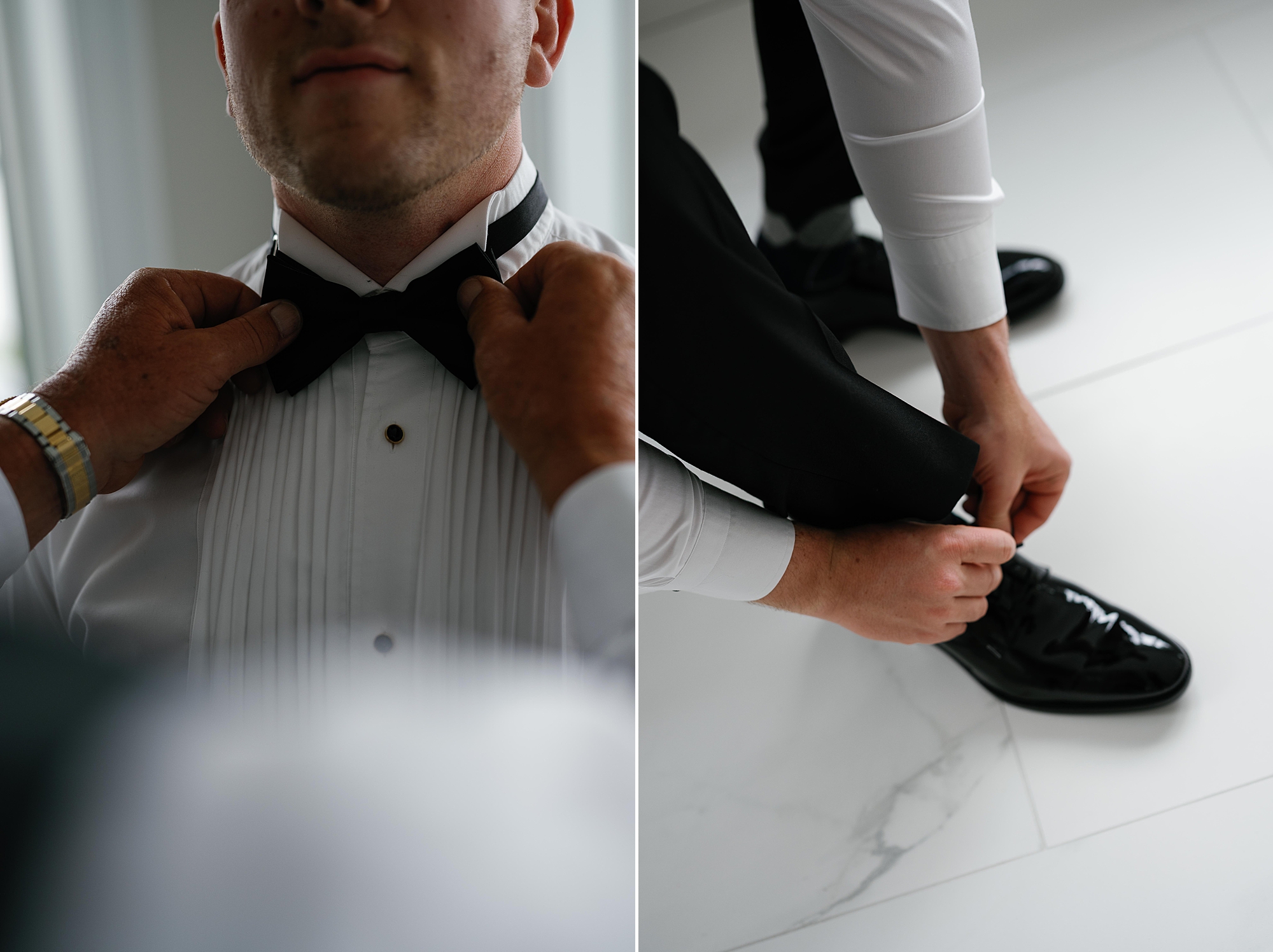 groom adjusts bow tie and puts on black shoes