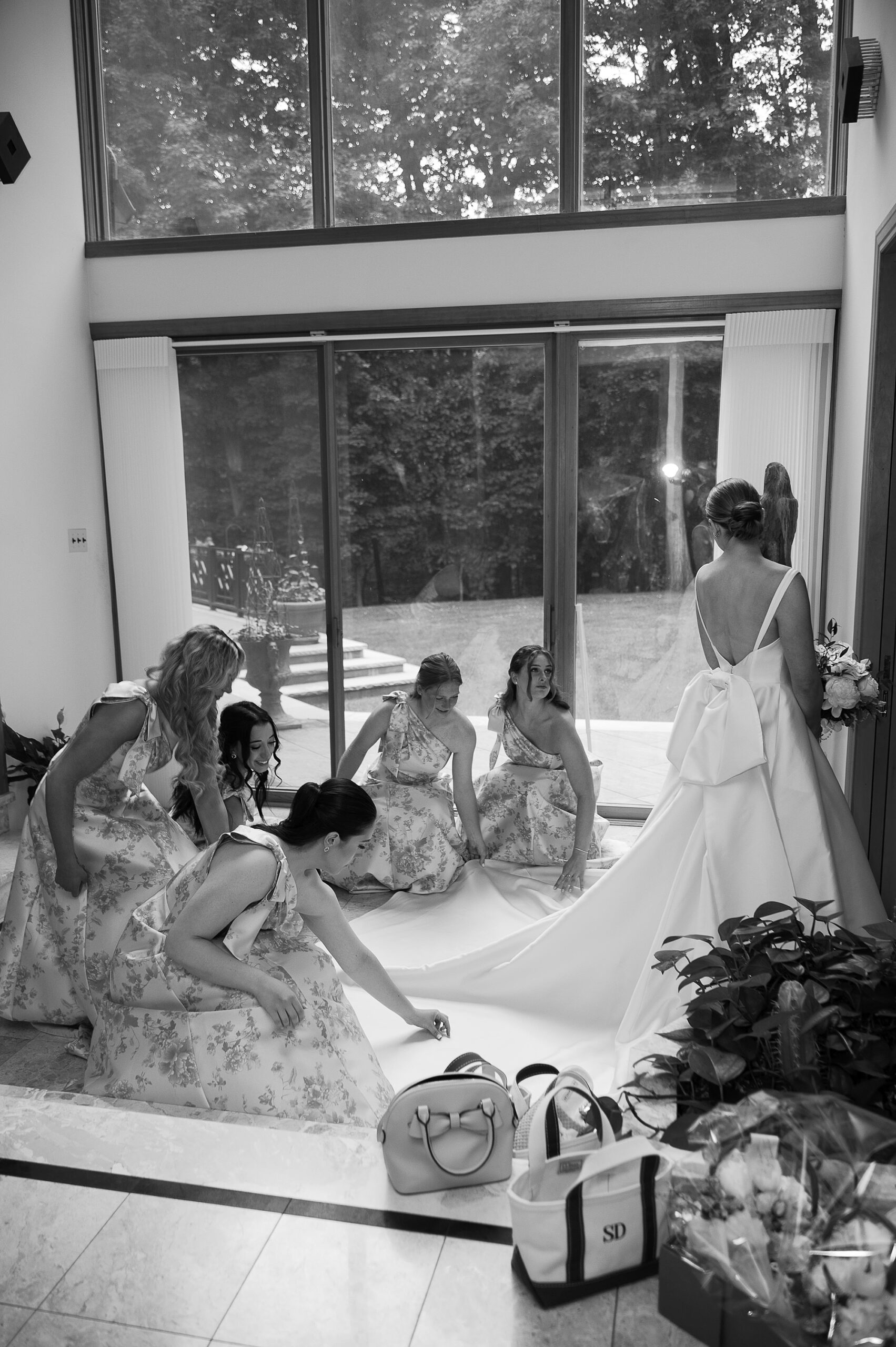 bridesmaids assist bride with skirt of wedding gown before Bronxville Field Club wedding