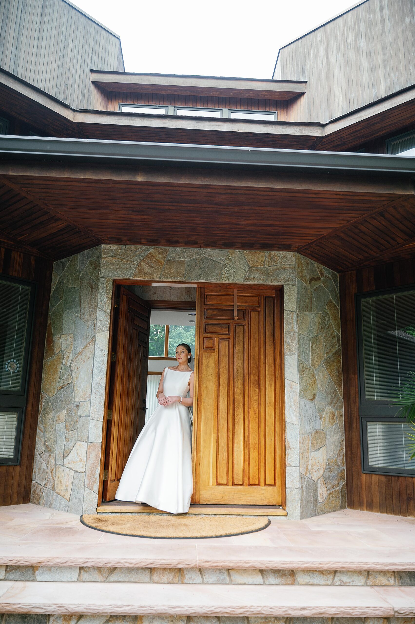 bride leans against wooden door of the Immaculate Conception Church
