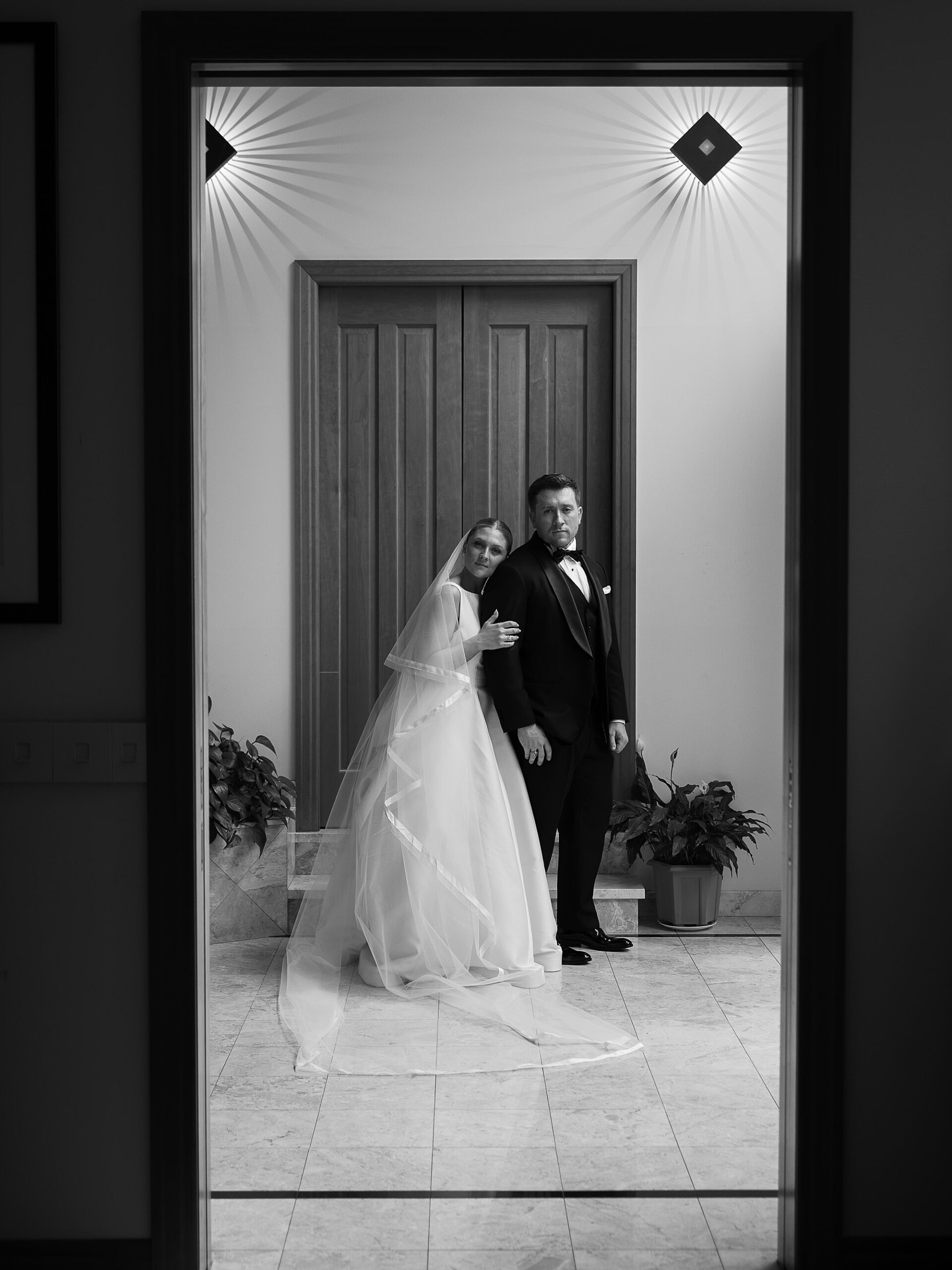 bride leans on groom's shoulder from behind at the Bronxville Field Club
