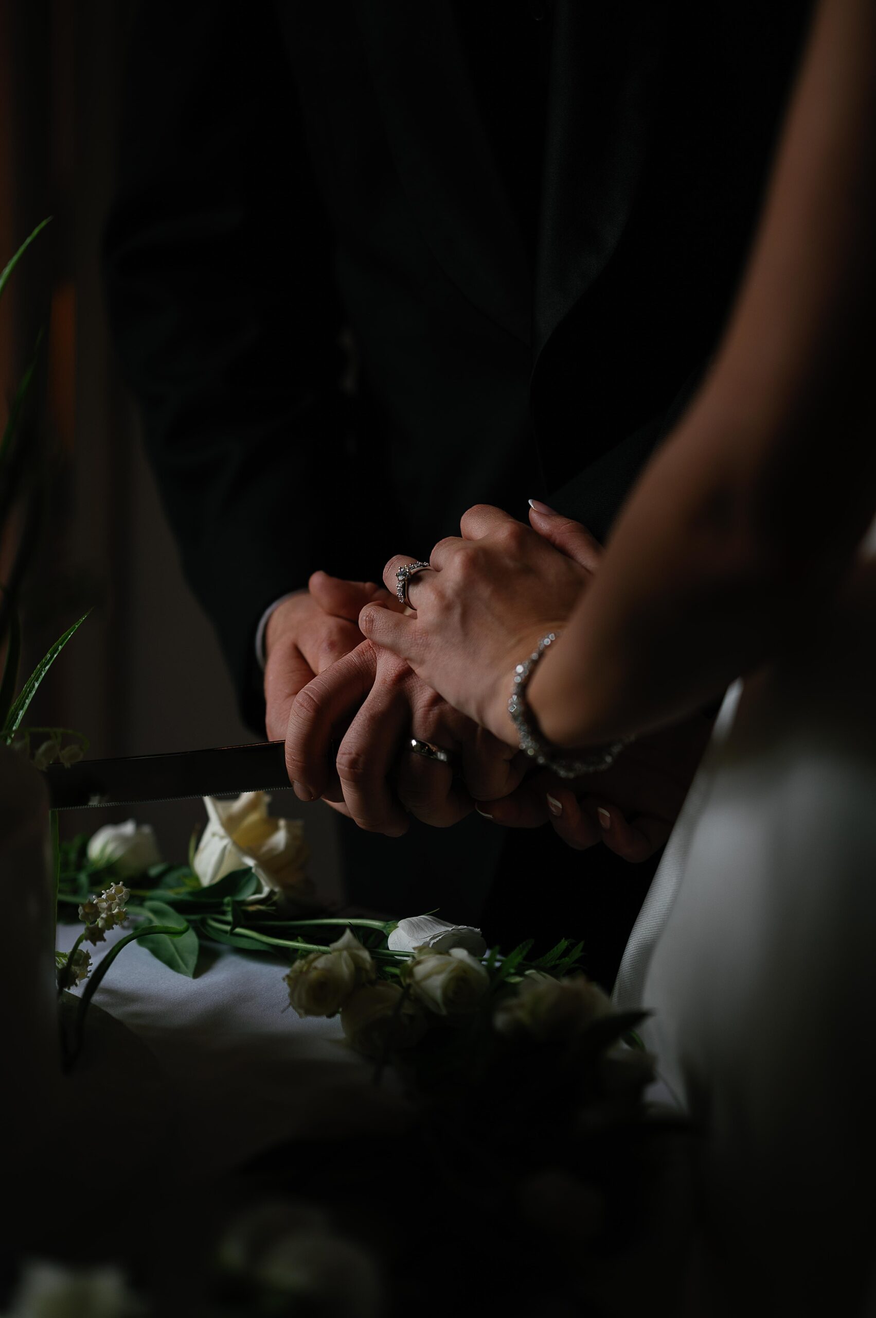 closeup of bride and groom cutting wedding cake during the Bronxville Field Club wedding reception