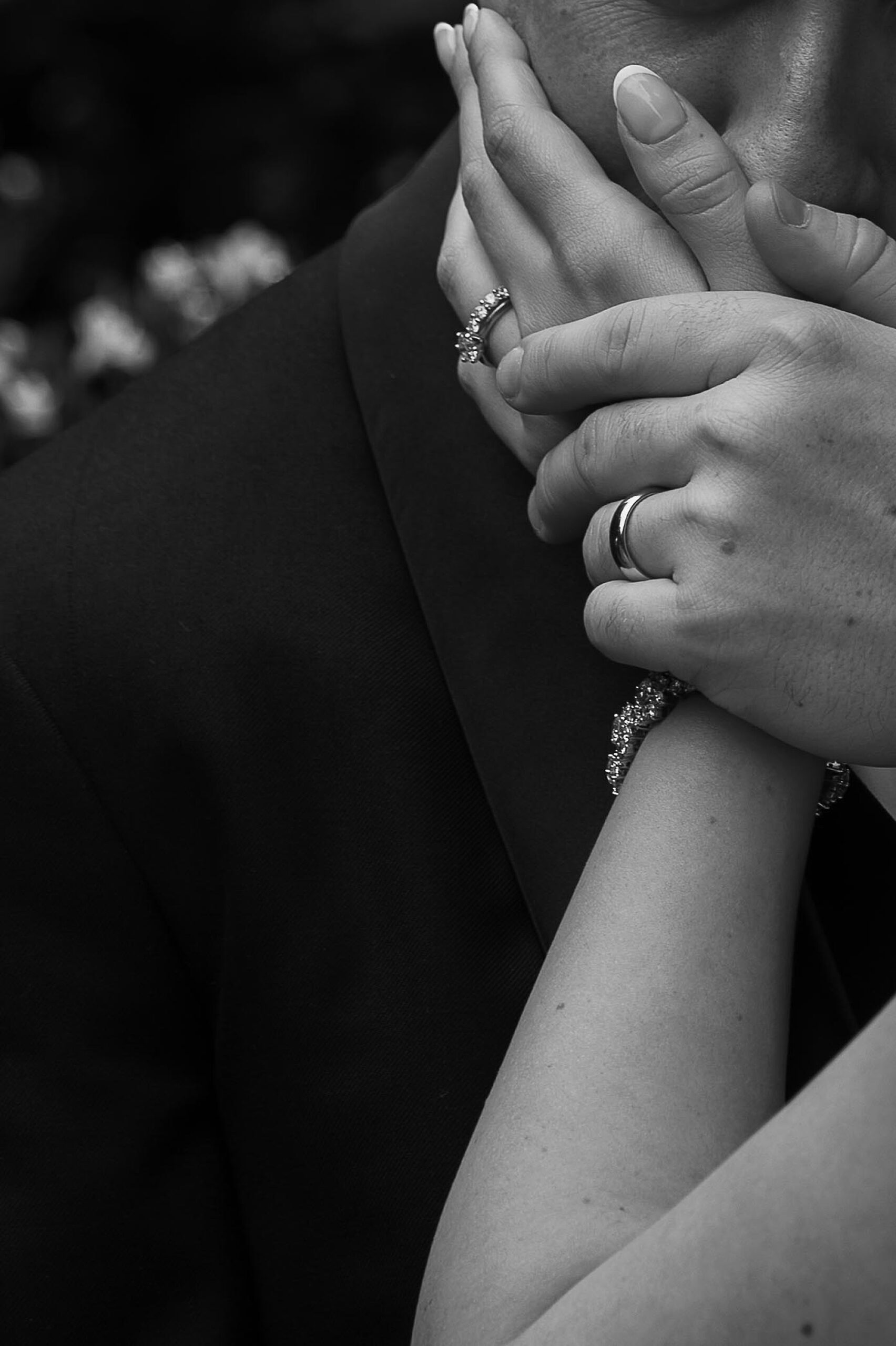 closeup of man and woman's hands on man's chest
