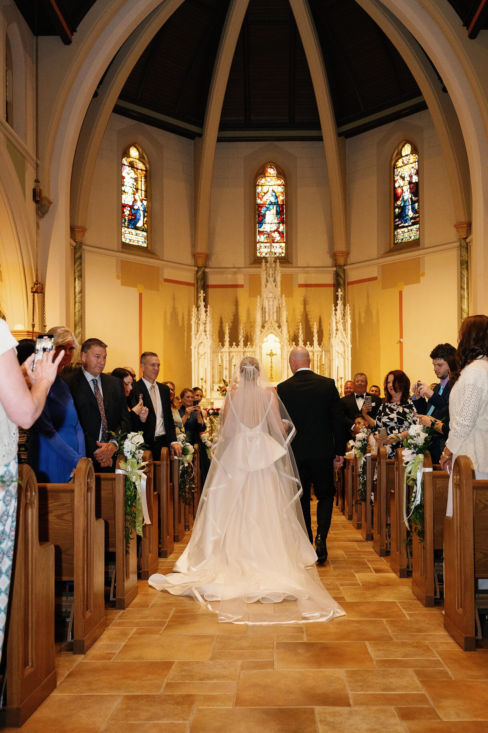 father escorts bride down aisle at the Immaculate Conception Church